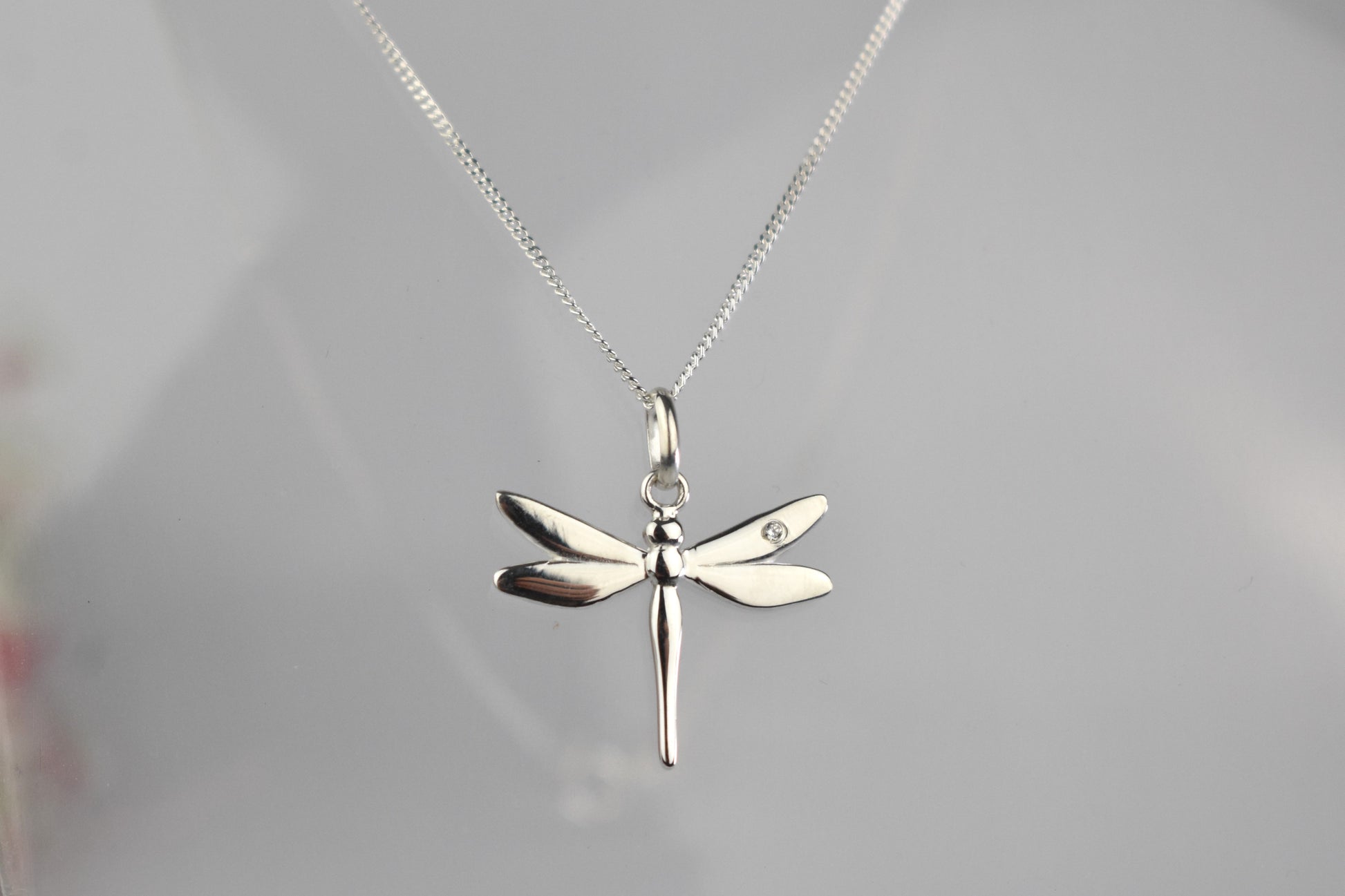 Dragonfly is sterling silver with a sparkling cubic zirconia crystal on its wing.