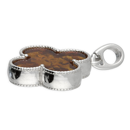 Quatrefoil-shaped pendant inlaid with genuine cognac amber. Finely textured Sterling silver edging. Pendant hangs from a sterling silver chain.