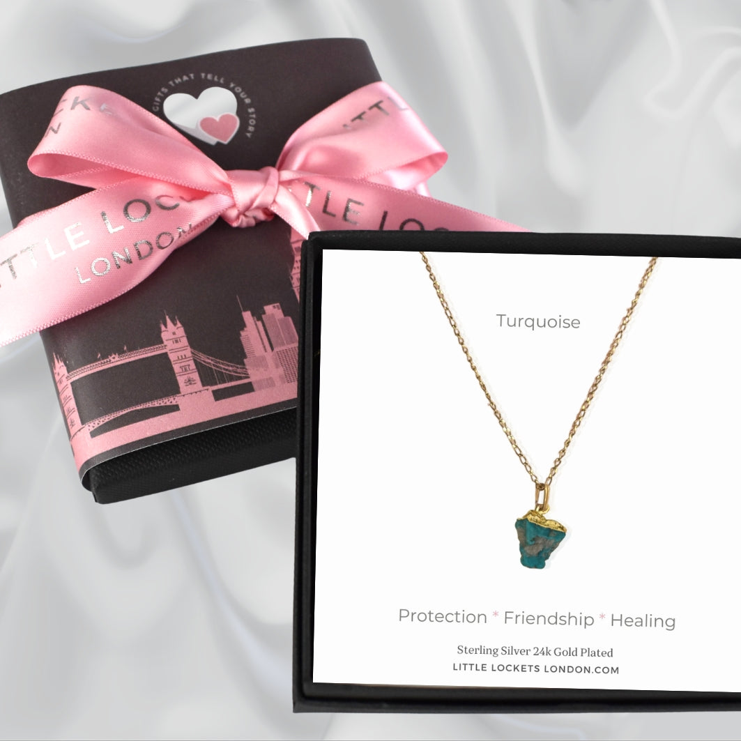 Raw crystal pendant shown in gift box with meaning card