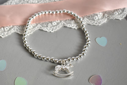 Silver bracelet with a rocking horse charm