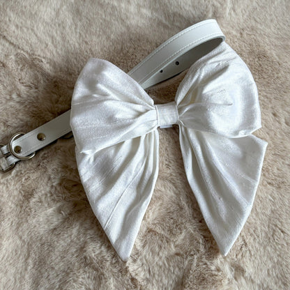White silk dupion sailor bow threads on to white leather collar and is easily removable for later wear