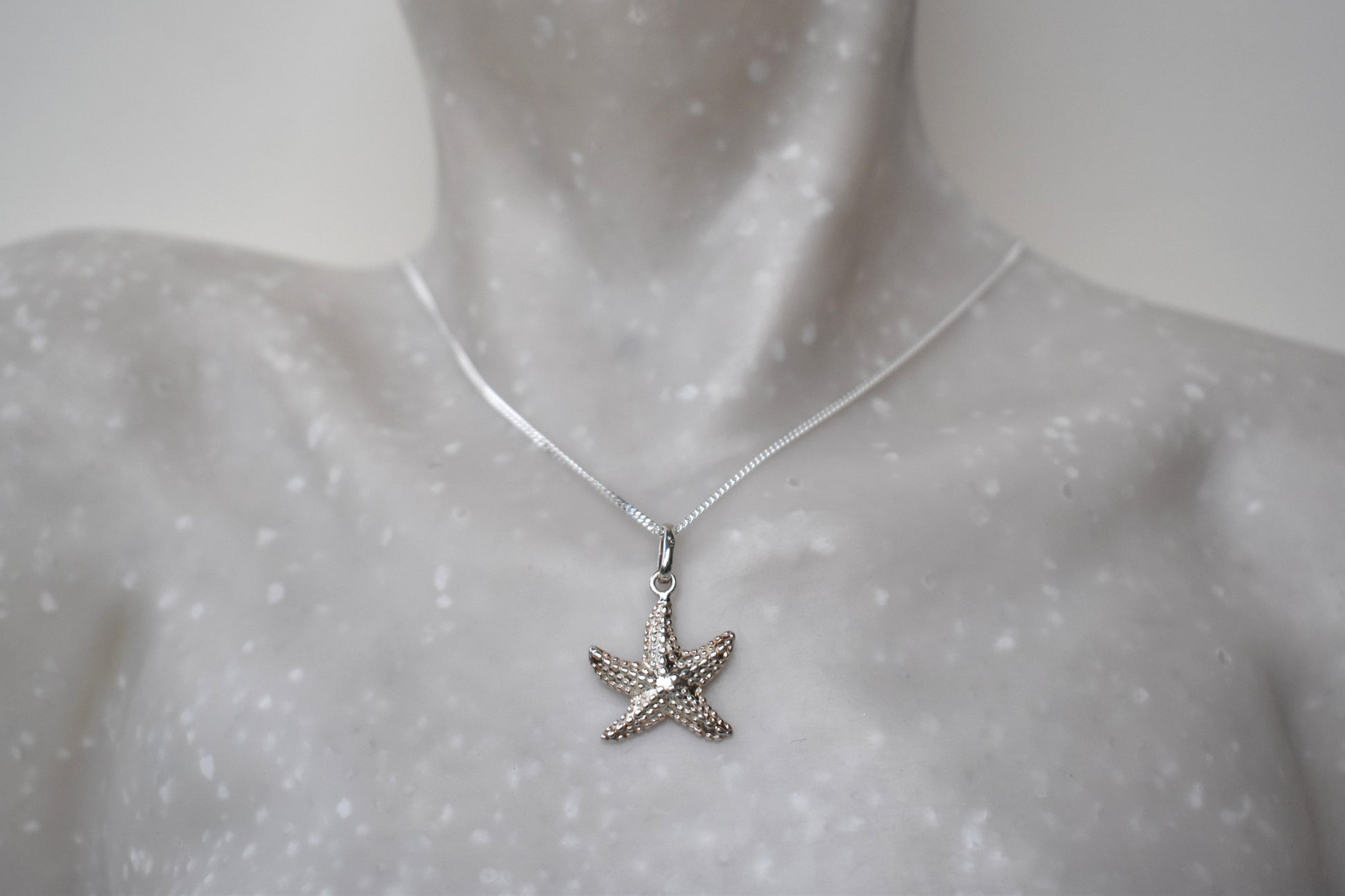 sterling silver starfish suspended from an adjustable 16-18" sterling silver chain.