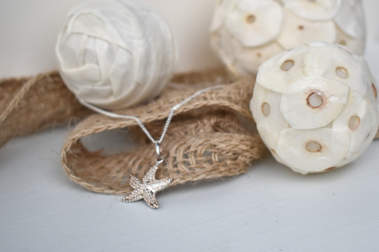 sterling silver textured starfish pendant suspended from an adjustable 16-18" sterling silver chain.