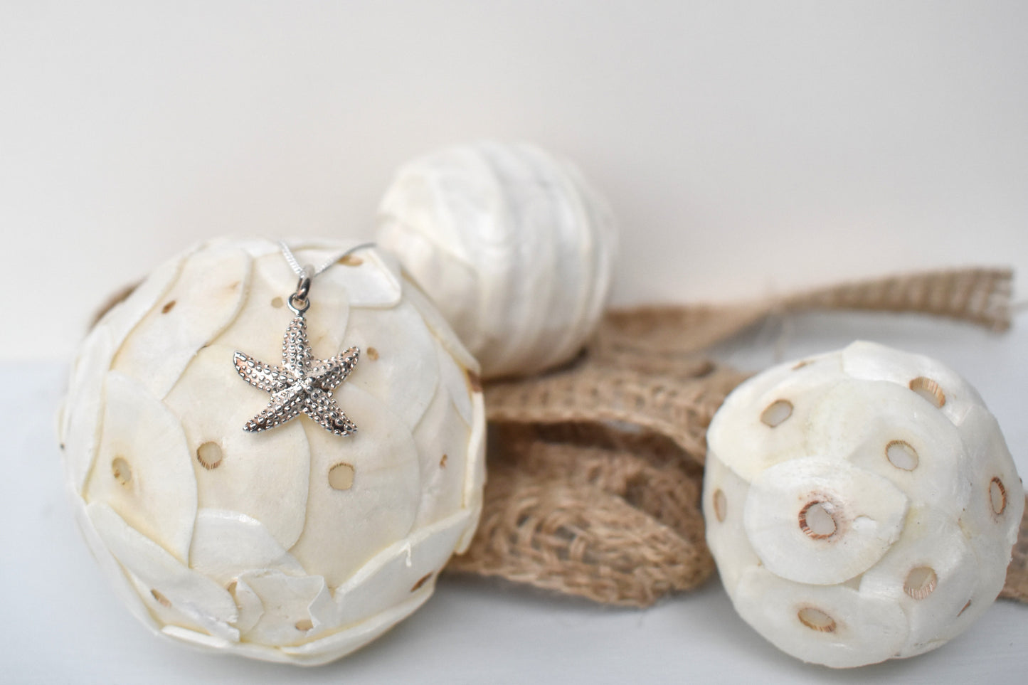 sterling silver textured starfish pendant suspended from an adjustable 16-18" sterling silver chain.