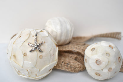 sterling silver textured starfish pendant suspended from an adjustable 16-18" sterling silver chain.