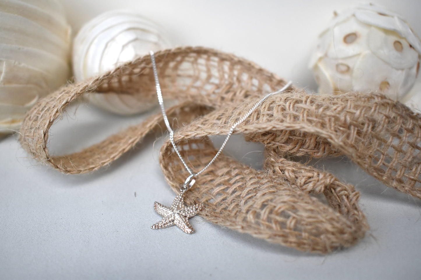 sterling silver textured starfish pendant suspended from an adjustable 16-18" sterling silver chain.