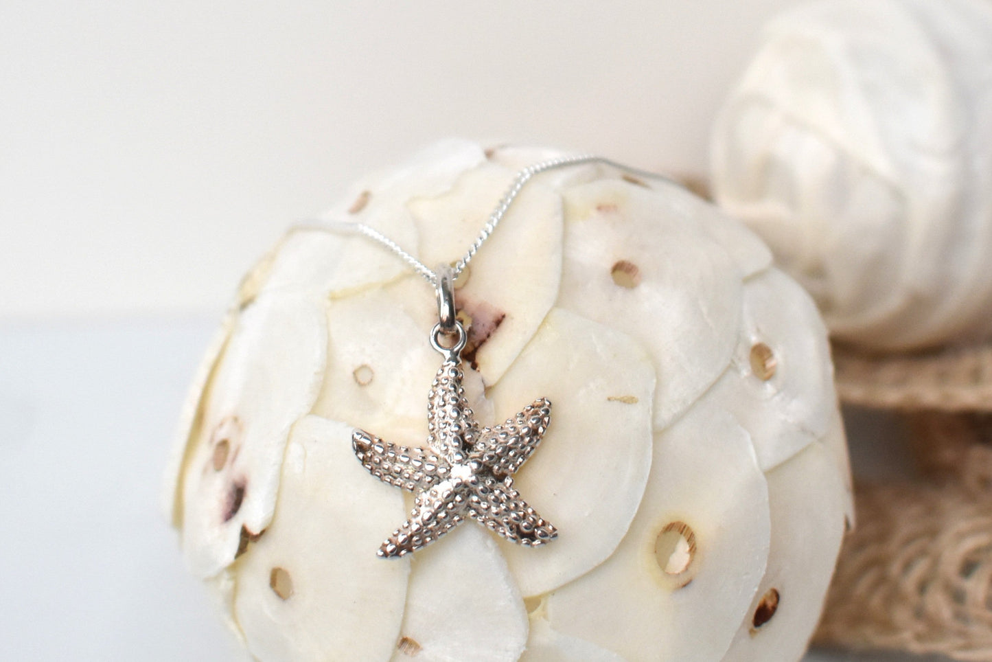 sterling silver textured starfish pendant suspended from an adjustable 16-18" sterling silver chain.