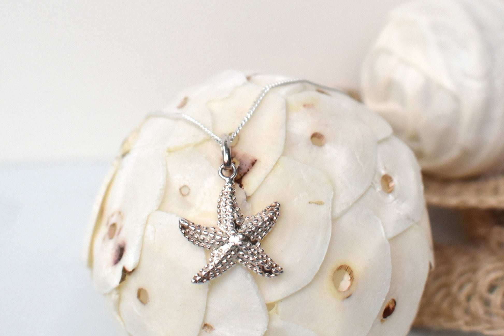 sterling silver textured starfish pendant suspended from an adjustable 16-18" sterling silver chain.