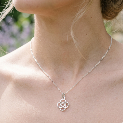 Celtic Knot Pendant Necklace shown in sterling silver. A Celtic Knot charm hanging from a cable chain.