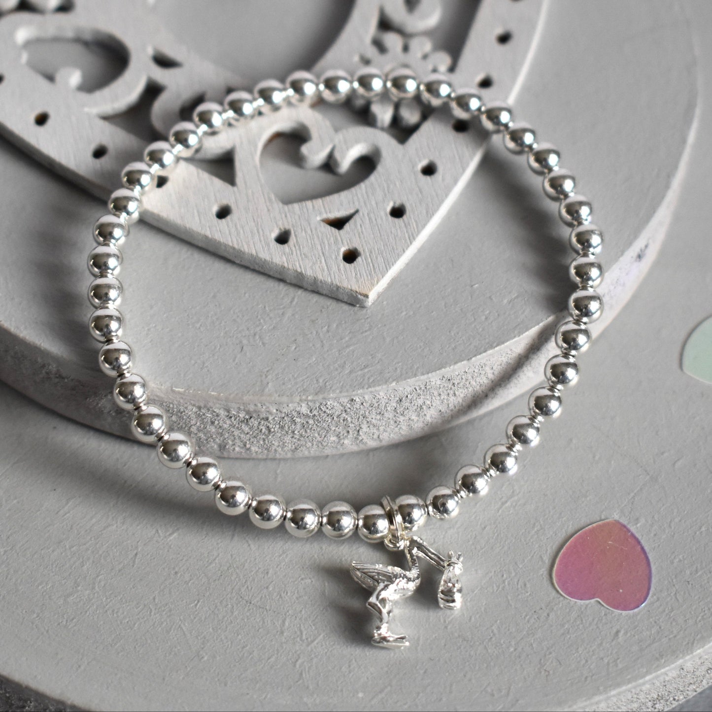4mm sterling silver beads are threaded onto strong elastic from which is suspended a sterling silver stork carrying a little bundle. The perfect bracelet for new mums.