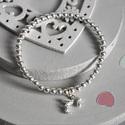4mm sterling silver beads are threaded onto strong elastic from which is suspended a sterling silver stork carrying a little bundle. The perfect bracelet for new mums.