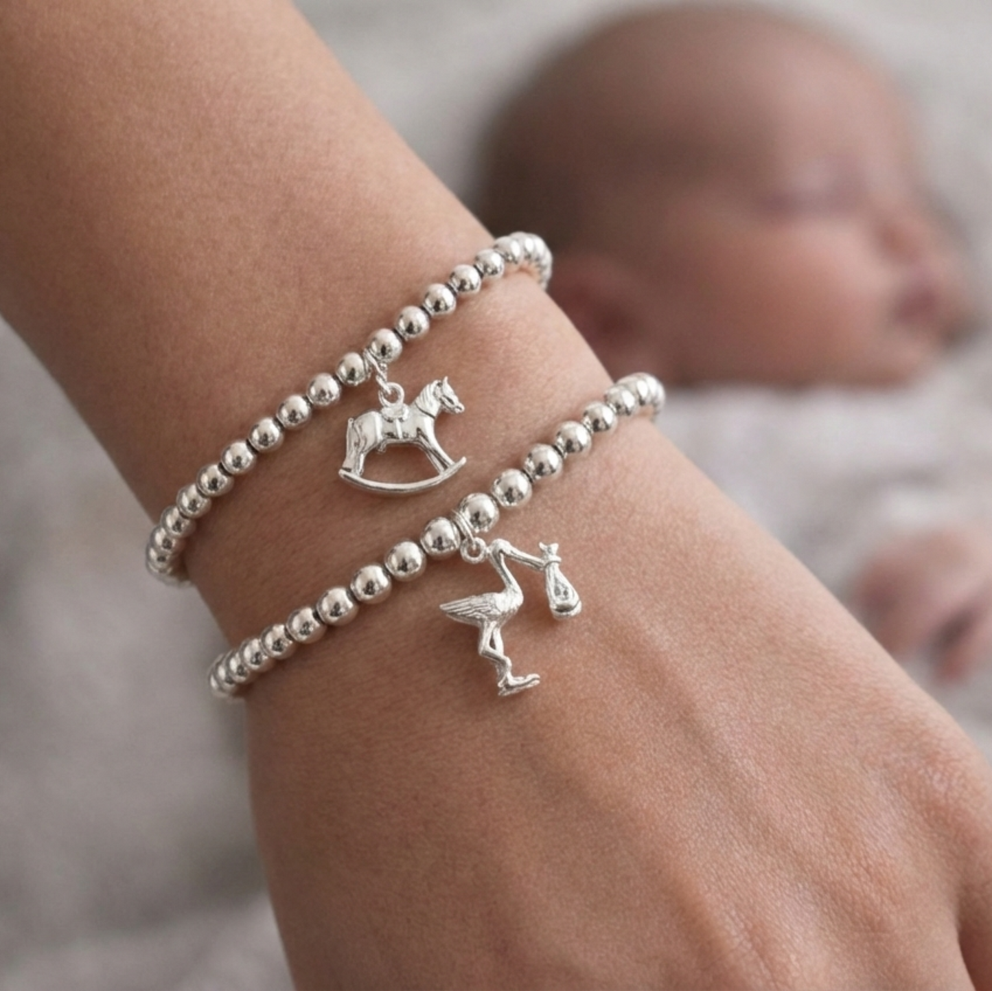 Sterling silver beaded bracelets, one with a Rocking Horse charm and the other with a Stork charm - perfect for new mums
