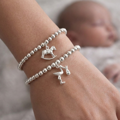 Sterling silver beaded bracelets, one with a Rocking Horse charm and the other with a Stork charm - perfect for new mums