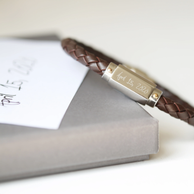 A brown twisted leather bracelet with a stainless steel central plate with your engraving