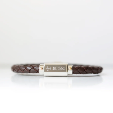 A brown twisted leather bracelet with a stainless steel central plate with your engraving