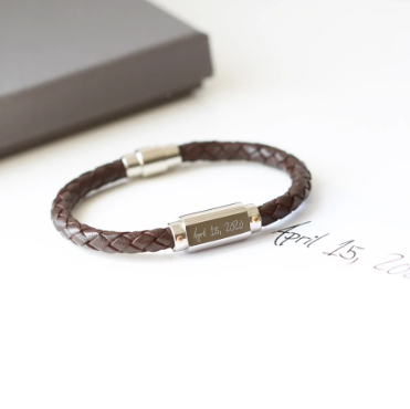 A brown twisted leather bracelet with a stainless steel central plate with your engraving