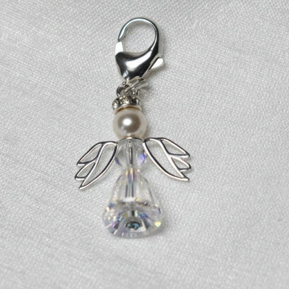 A crystal and pearl angel attached to a strong sterling silver caribiner