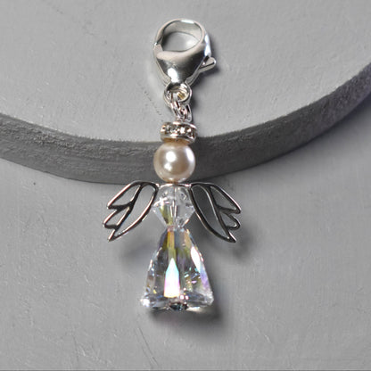 A crystal and pearl angel attached to a strong sterling silver caribiner