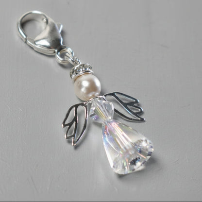 A crystal and pearl angel on a sterling silver caribiner. Ideal for bouquets, on a handbag or as a key charm. Shown with a tiny blue crystal at base, although this can be exchange for an alternative colour if preferred.