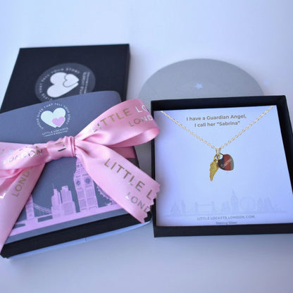 A sterling silver heart engraved with your choice of name and a gold vermeil angel wing, boxed with a message that she has a guardian angel.