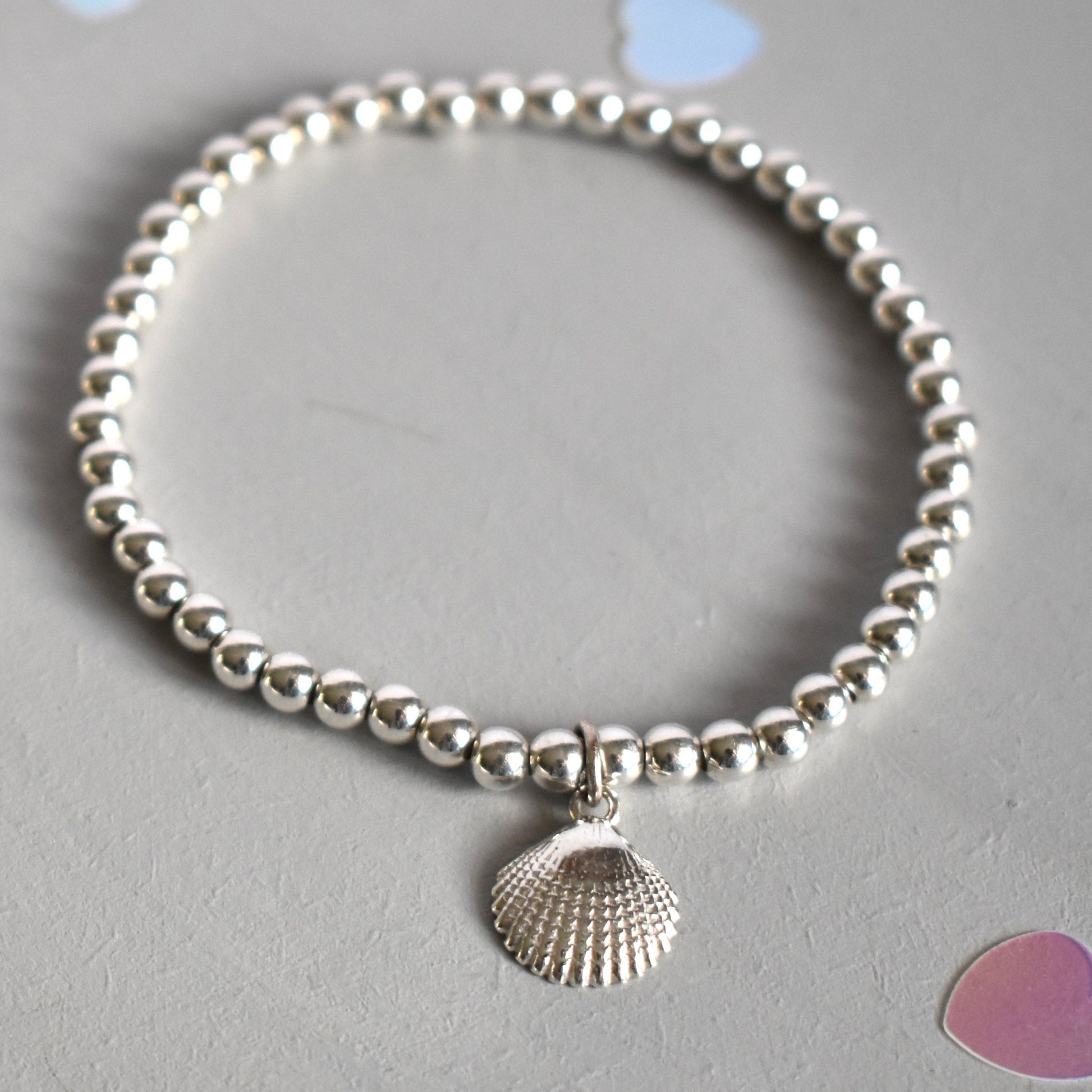 Sterling silver beaded bracelet with 4mm beads. Suspended from the bracelet  is a sterling silver clamshell. 