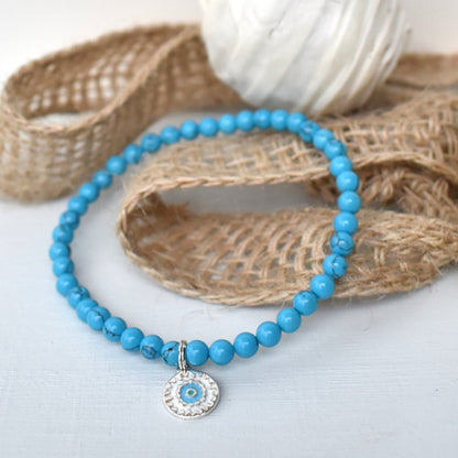 Elasticated bracelet with 4mm reconstituted turquoise beads and a perfect sterling silver mandala charm, make the perfect beach bracelet.