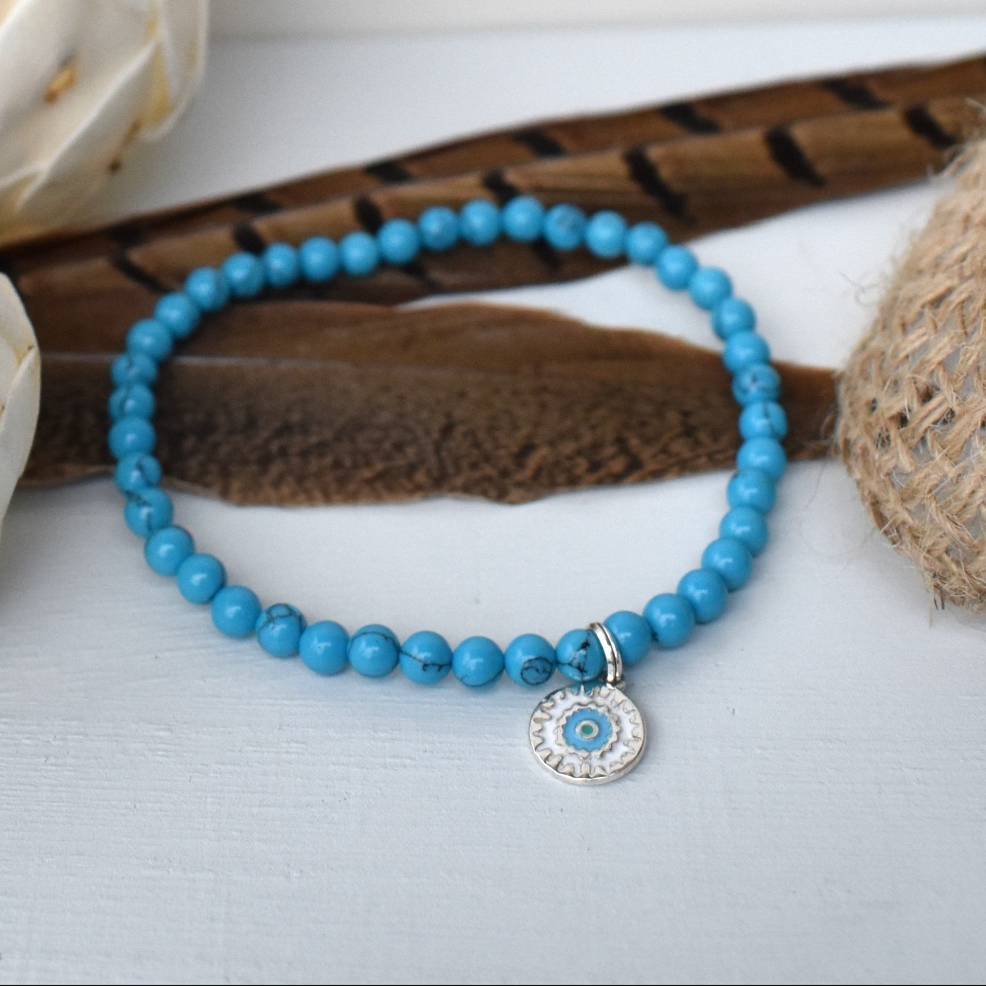 Elasticated bracelet with 4mm reconstituted turquoise beads and a perfect sterling silver mandala charm, make the perfect beach bracelet.