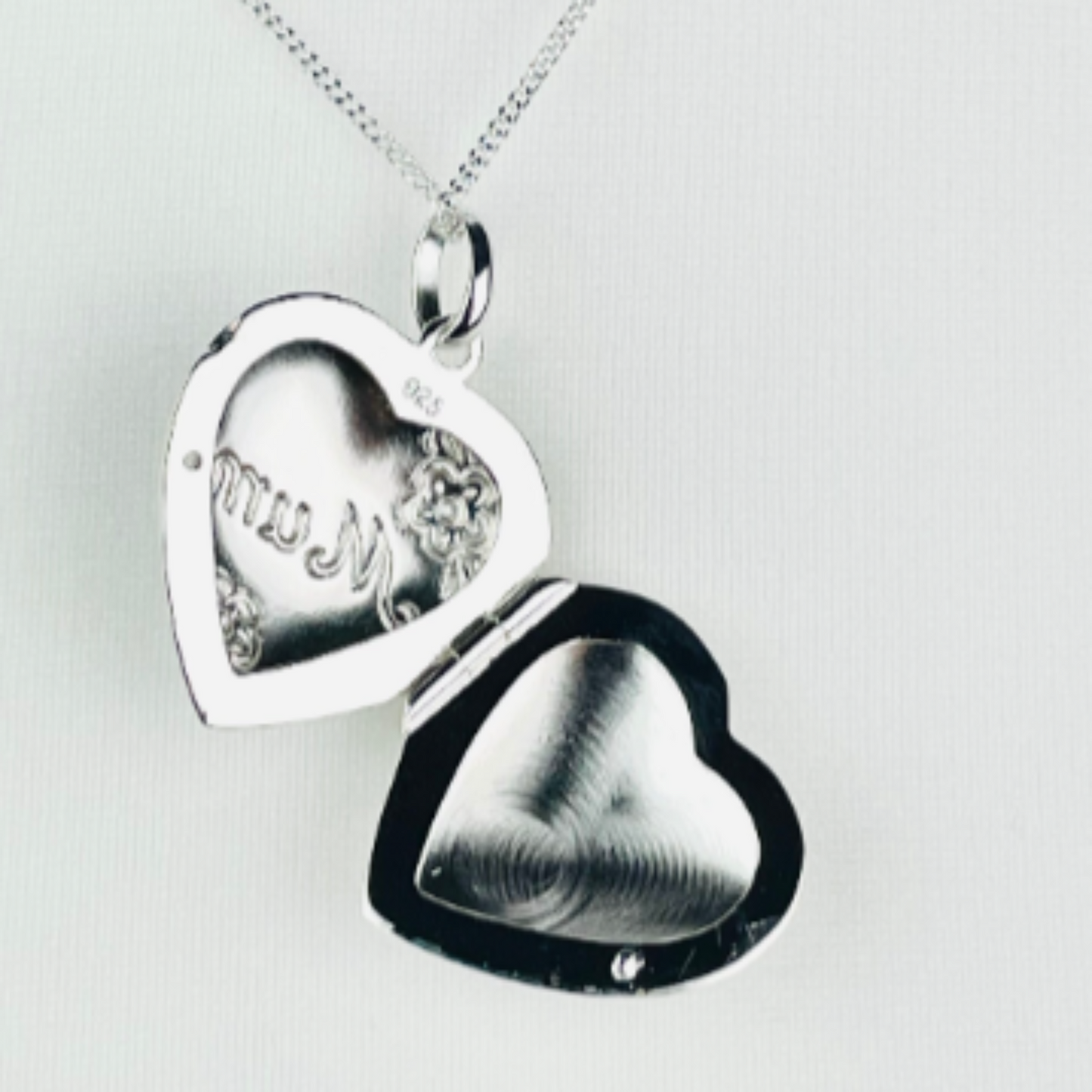 Heart shaped photo locket features delicate flowers engraved on the front, along with Mum. Crafted from high-quality sterling silver, it comes with a 16-18 inch extendable chain