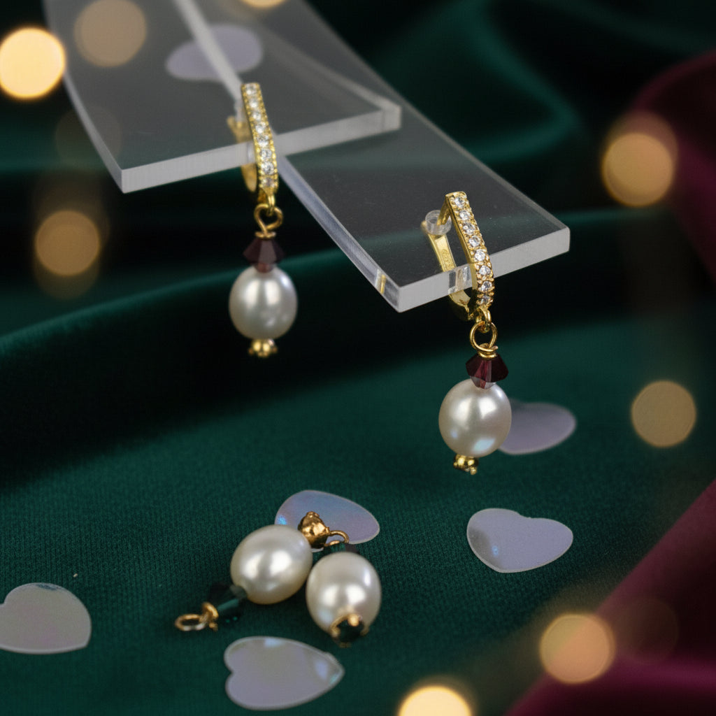 freshwater pearl earrings with emerald green Austrian crystals hung from your choice of sterling silver or gold platedear wires trimmed with diamante