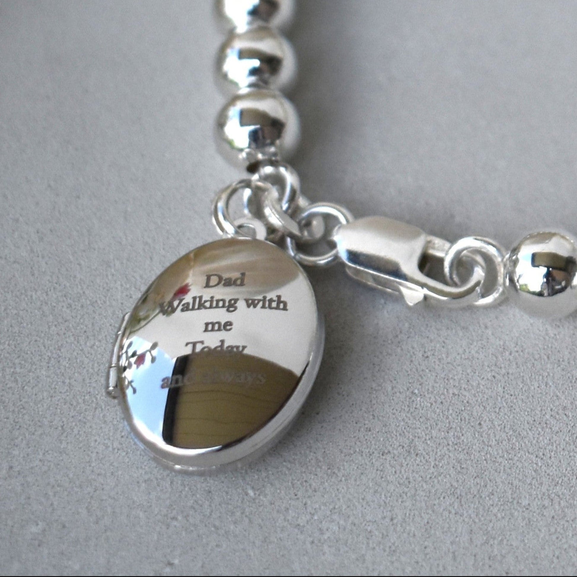 6mm sterling silver ball bracelet. Next to the lobster fastening is a sterling silver engraved locket which can be engraved with up to five lines of text for your own message. 