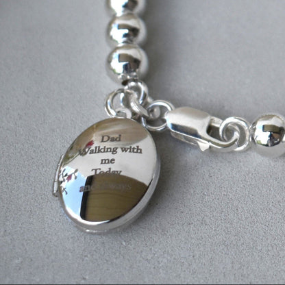6mm sterling silver ball bracelet. Next to the lobster fastening is a sterling silver engraved locket which can be engraved with up to five lines of text for your own message. 
