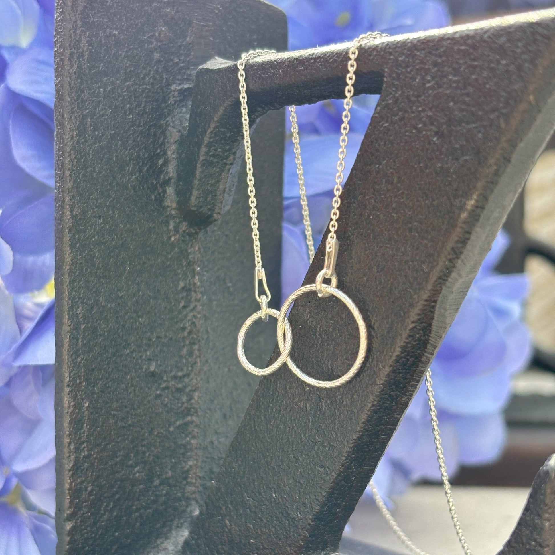 Sterling silver sparkly entwined circles shown on sterling silver chain.