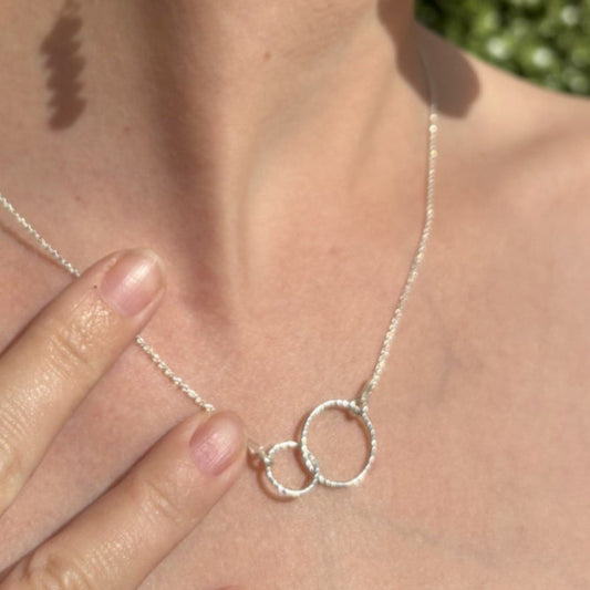 Sterling silver sparkly entwined circles on an adjustable sterling silver chain