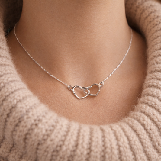 Sterling silver entwined hearts necklace shown worn 