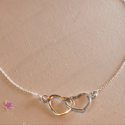Sterling silver necklace with entwined hearts link. 
