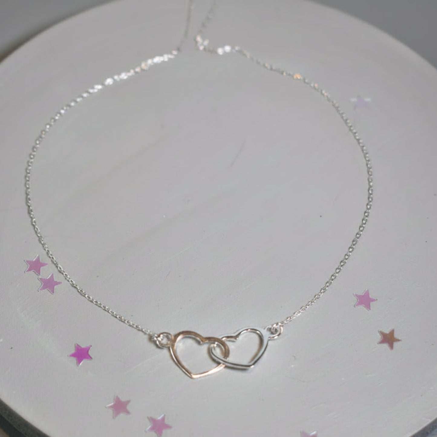 Sterling silver necklace with entwined hearts link. 
