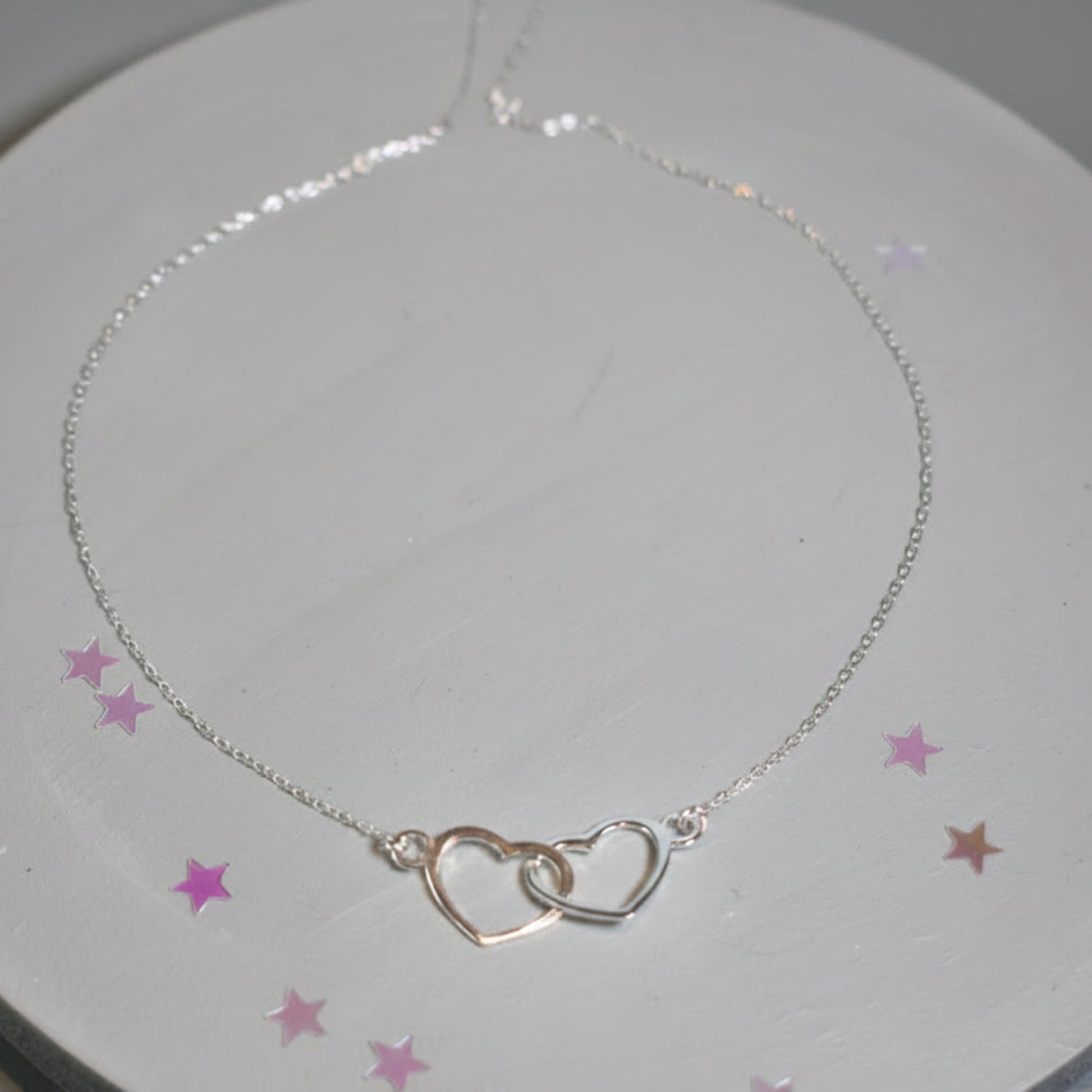 Sterling silver necklace with entwined hearts link. 
