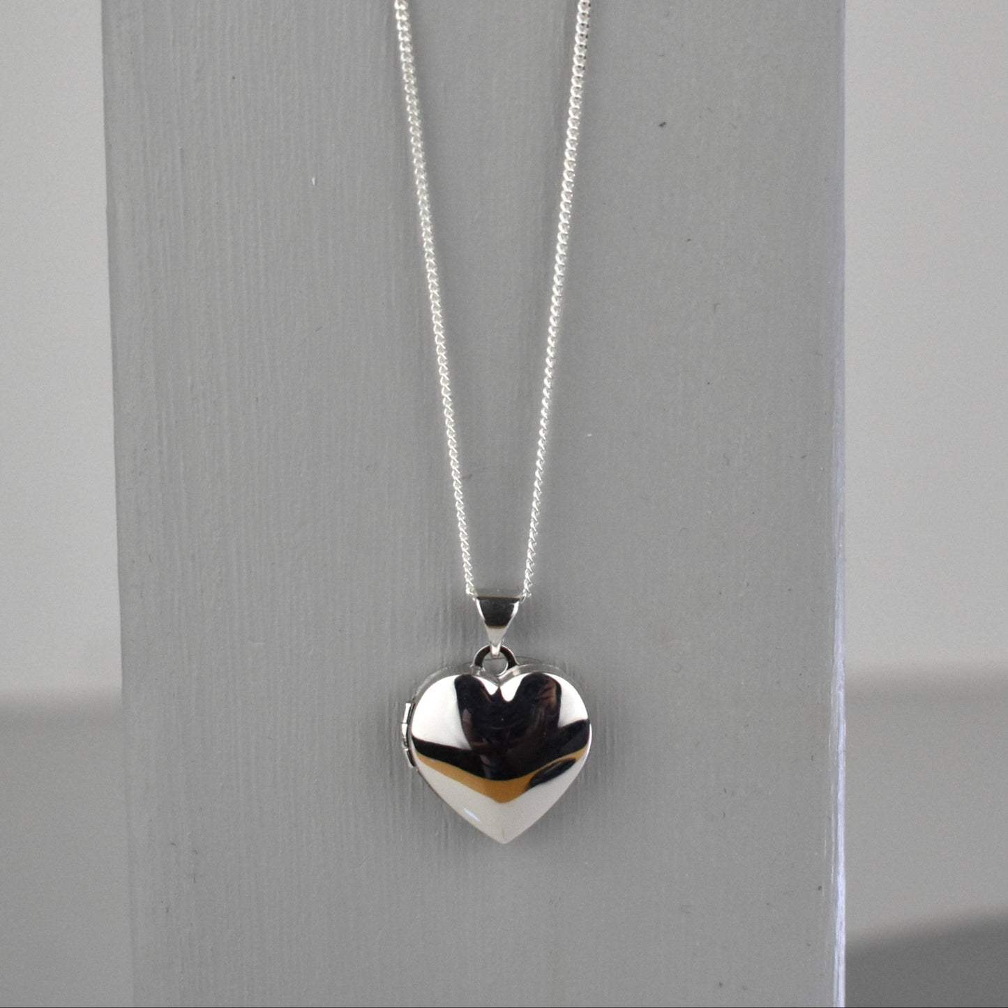 sterling silver heart locket on 14" sterling silver chain. 