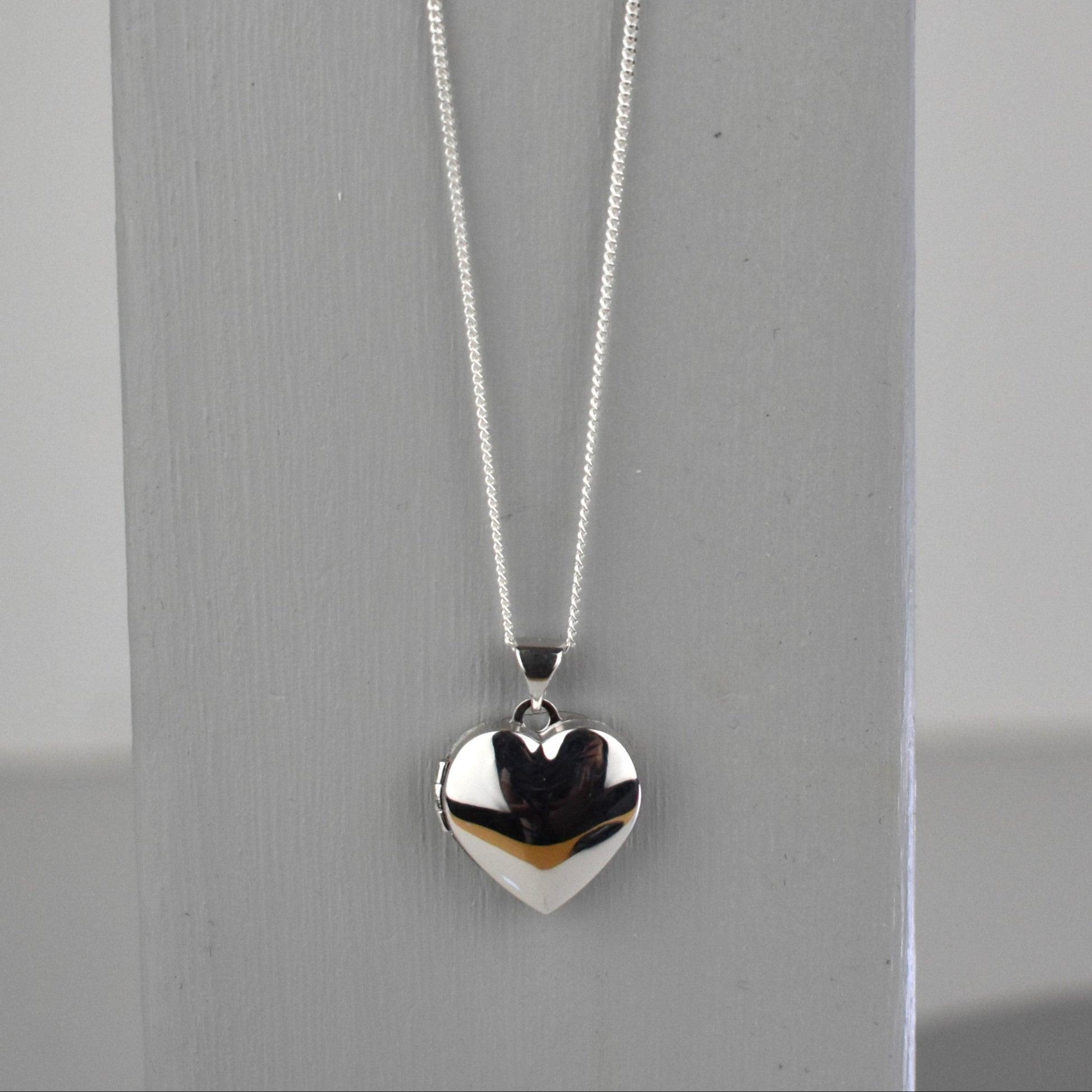sterling silver heart locket on 14" sterling silver chain. 