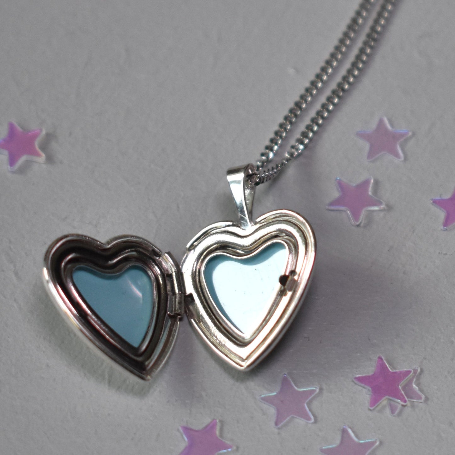 Heart shape locket opens to hold two photographs
