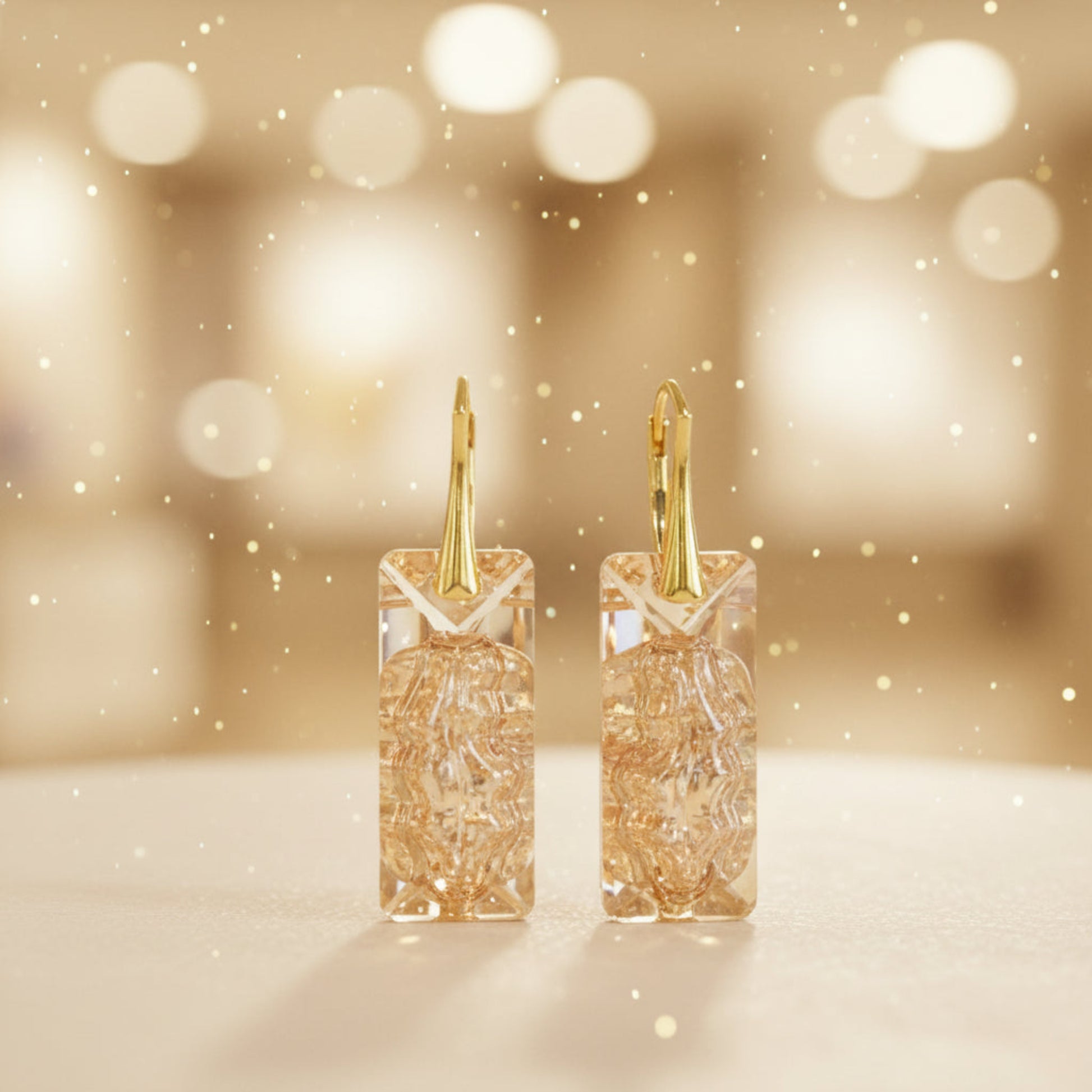 Highest quality Austrian crystal earrings shown in Golden Shadow,. The centre of the crystal is designed to look as if the crystal is still growing and catches the light beaufifully. Suspended from gold plated sterling silver lever back wires and gift boxed