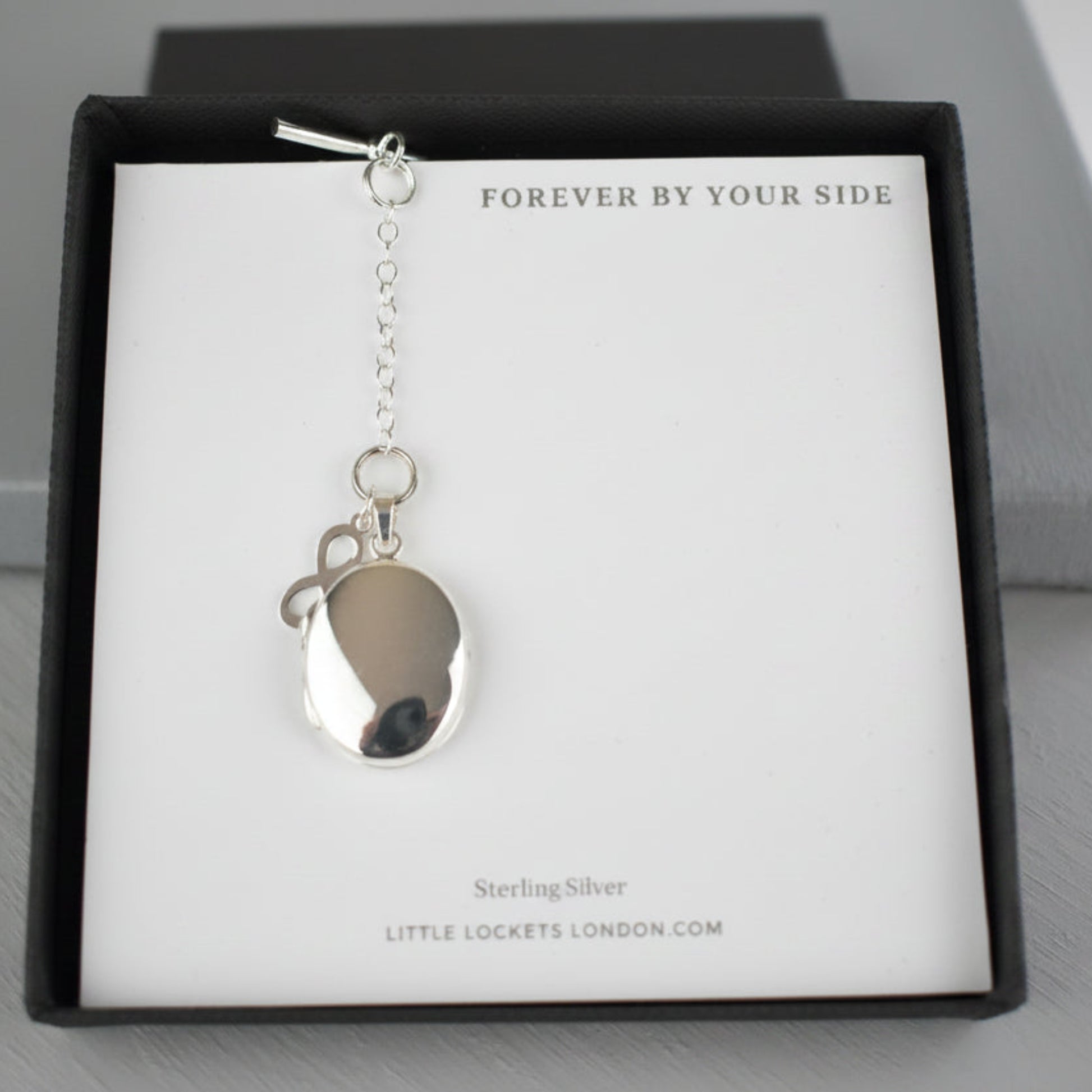 Sterling Silver Men's Photo Locket with a sterling silver Infinity charm. The Infinity charm makes a beautiful statement meaning everlasting, eternal and never-ending. The locket can hold up to two photographs.