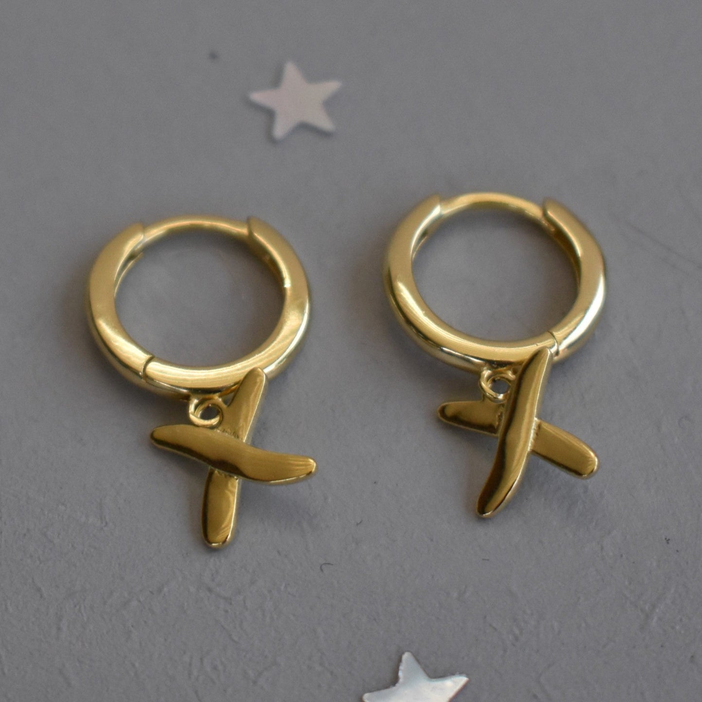 Huggie earrings to match our golden kisses necklace. 9mm  huggies gold plated on sterling silver have a "kiss" dangling from each earring.