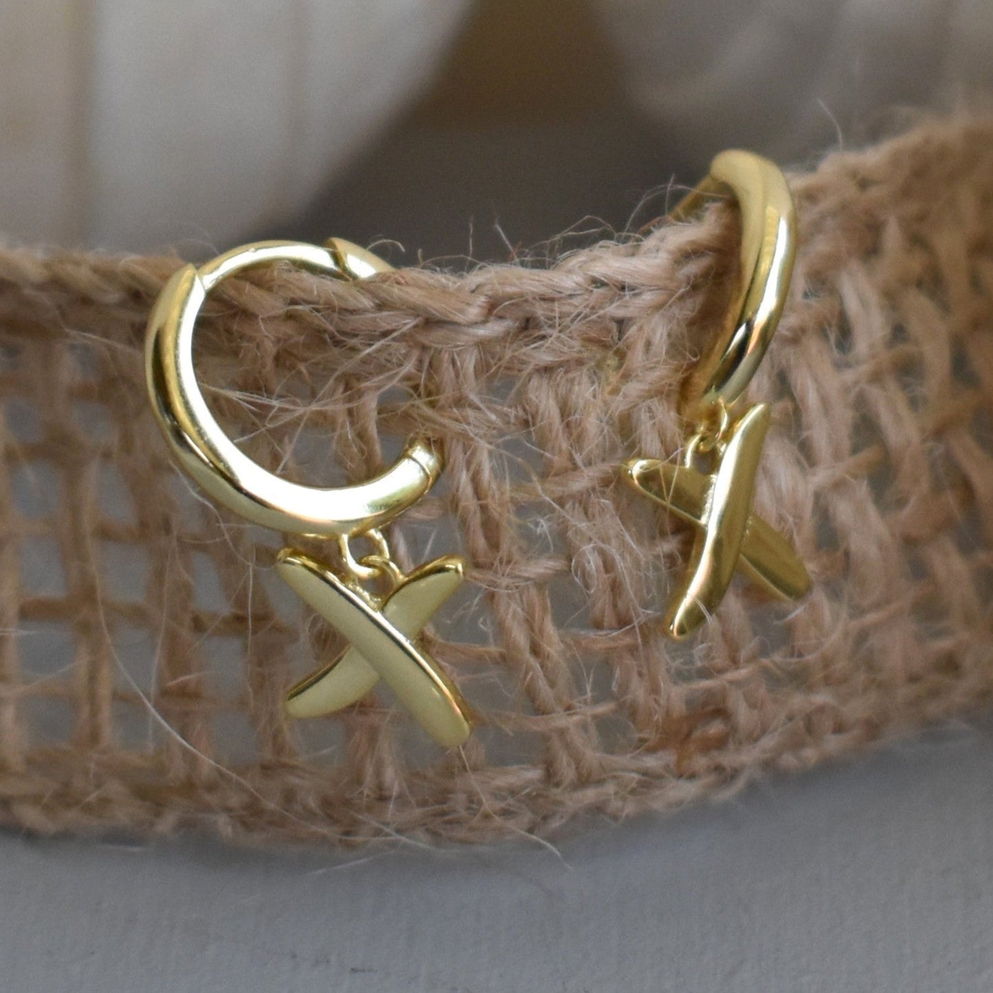 Huggie earrings to match our golden kisses necklace. 9mm  huggies gold plated on sterling silver have a "kiss" dangling from each earring.
