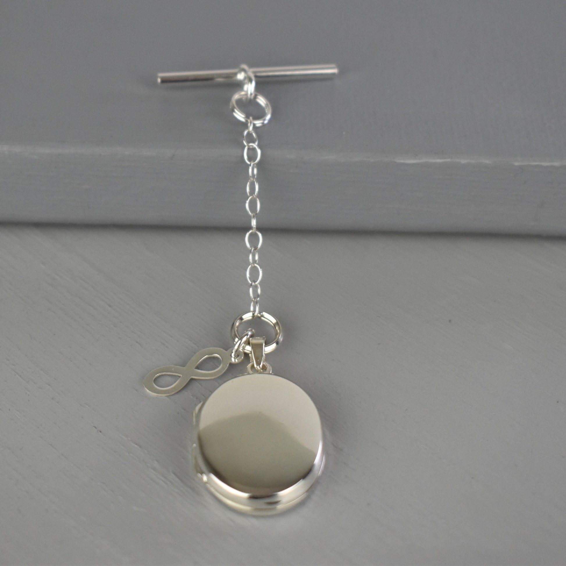 Sterling silver photo locket with infinity symbol and clasp