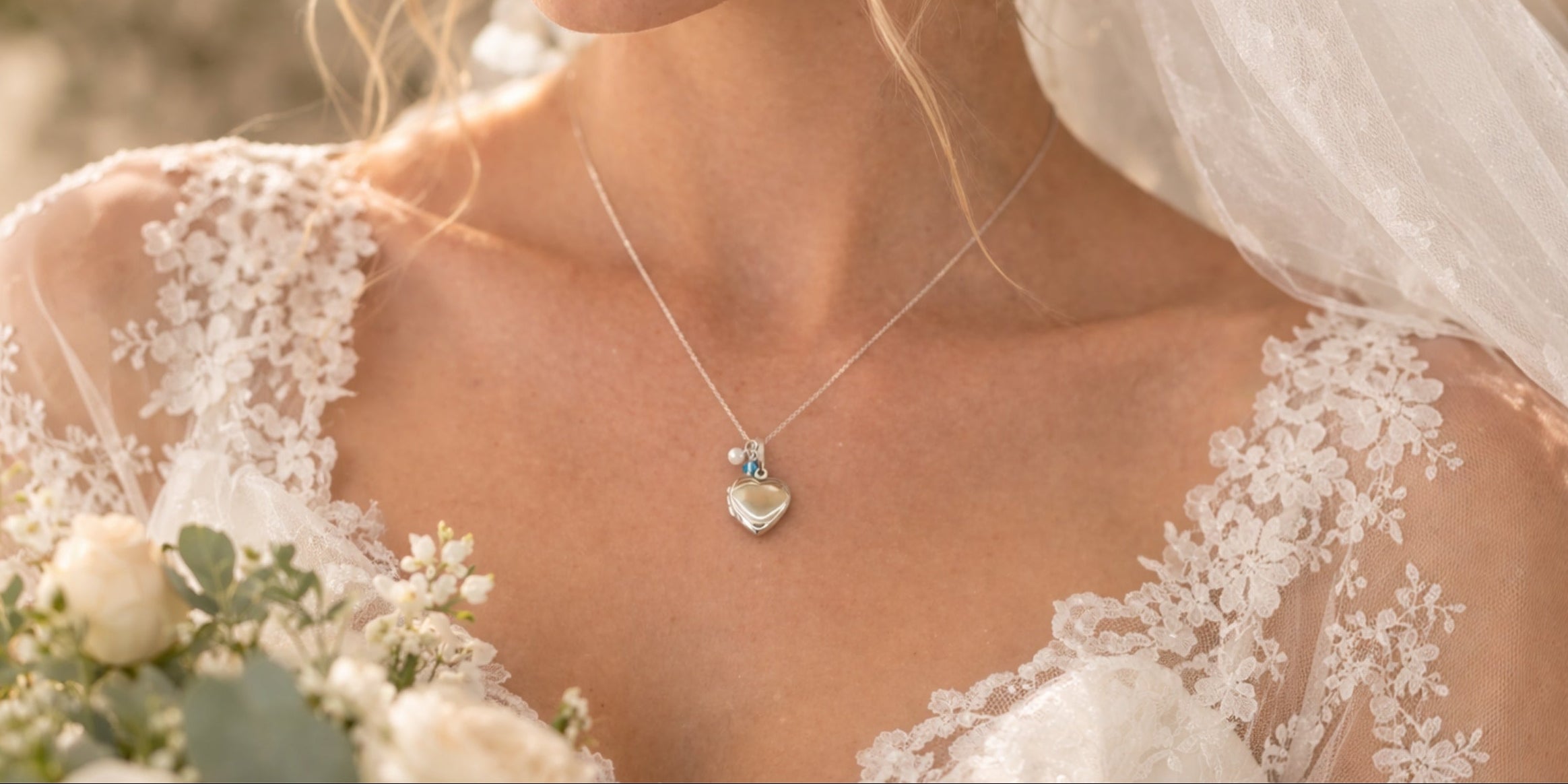 heart shaped locket with pearl and blue charm