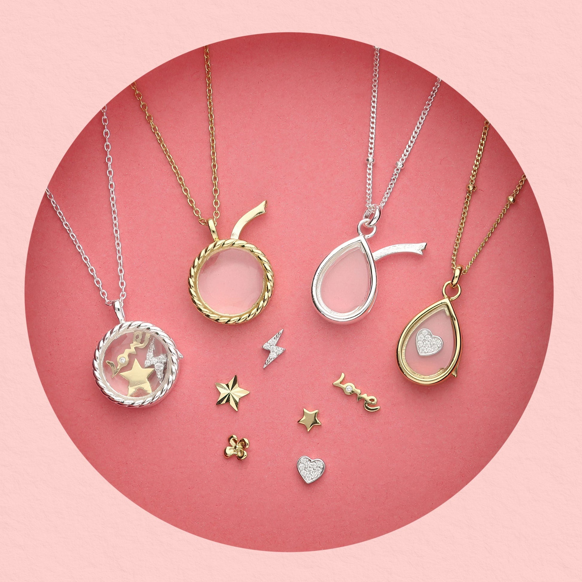 Collection of glass locket necklaces in gold and silver with interchangeable mini charms including stars, hearts, lightning bolt, and 'love' text charm,