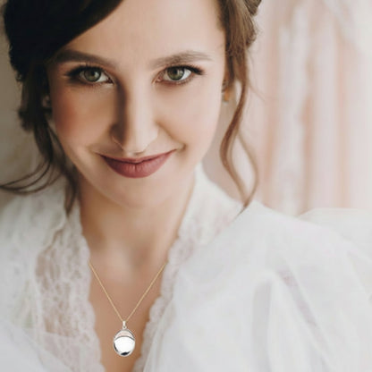 Sterling silver oval locket shown worn
