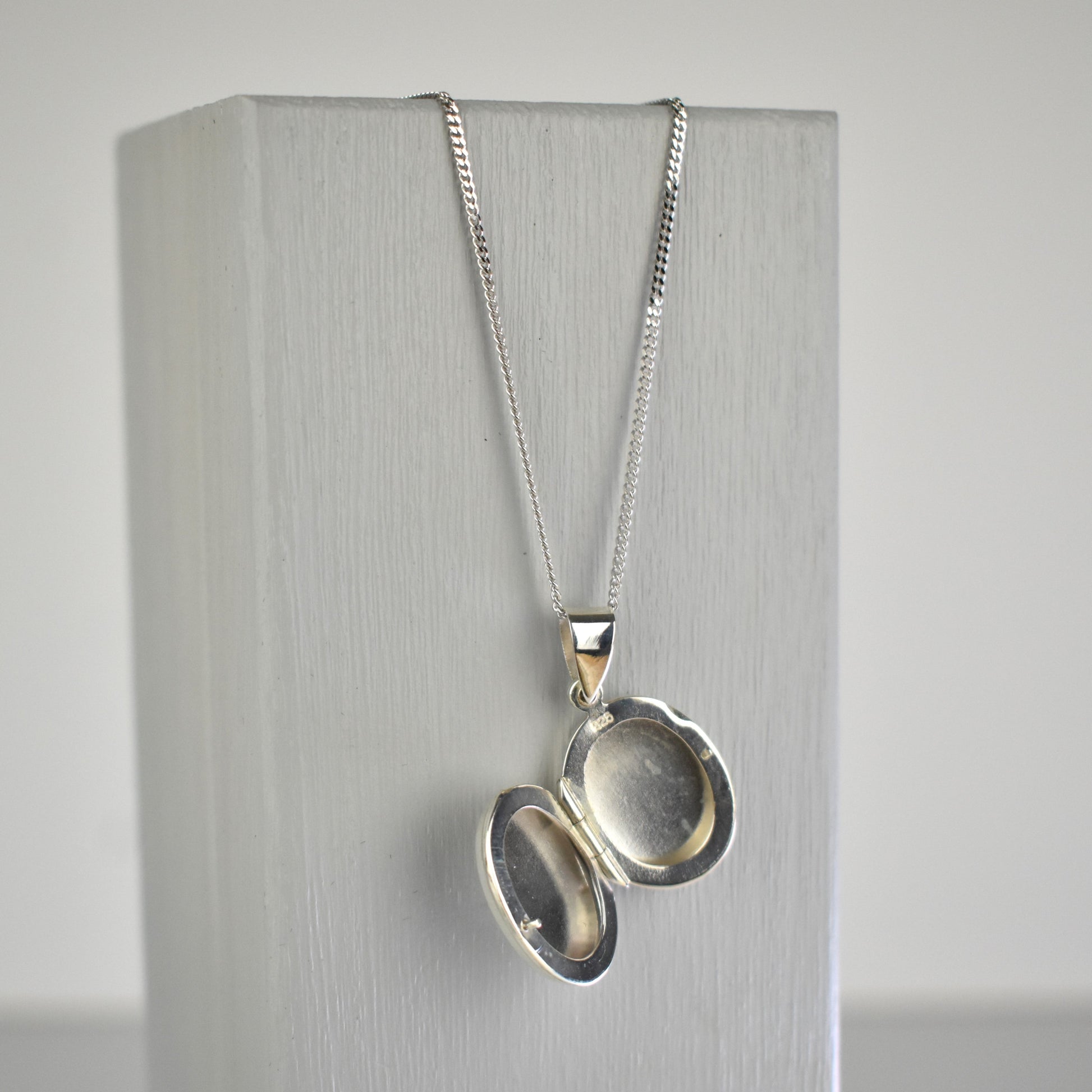 Sterling silver oval locket shown open