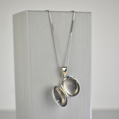 Sterling silver oval locket shown open